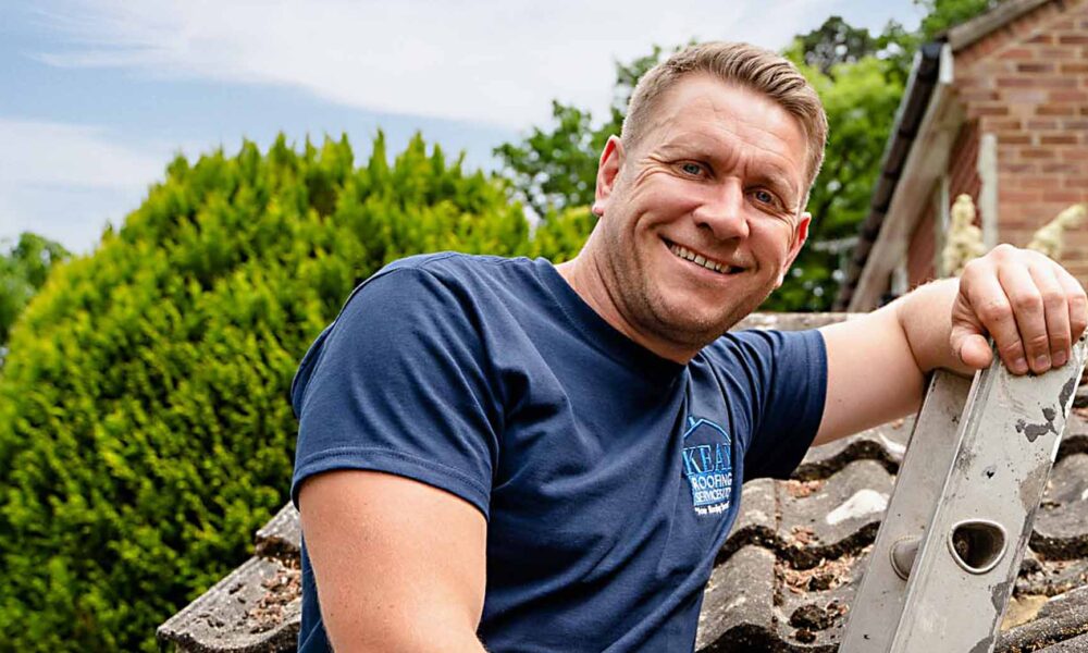 roofer up a ladder smiling